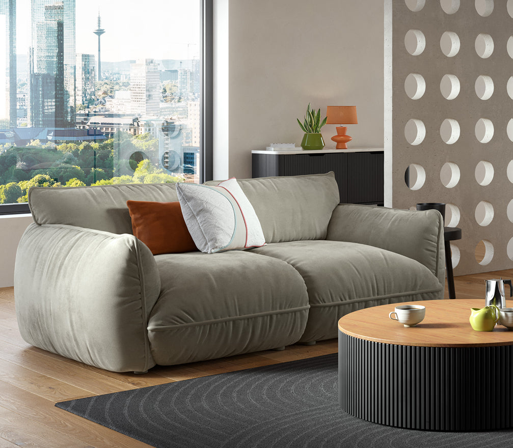 Ein Bild des Morandi Sofas in einem modernen Wohnzimmer. Mit seinen weichen Kurven und angenehmen Sitztiefe bereichert es jedes Wohnzimmer nicht nur als Ort der Entspannung, sondern auch visuell.