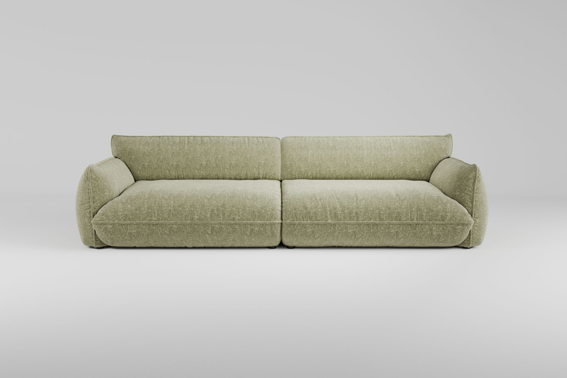 Hellgrünes, modernes Plüschsofa mit breiten Kissen und niedrigen Armlehnen auf einem schlichten weißen Hintergrund.