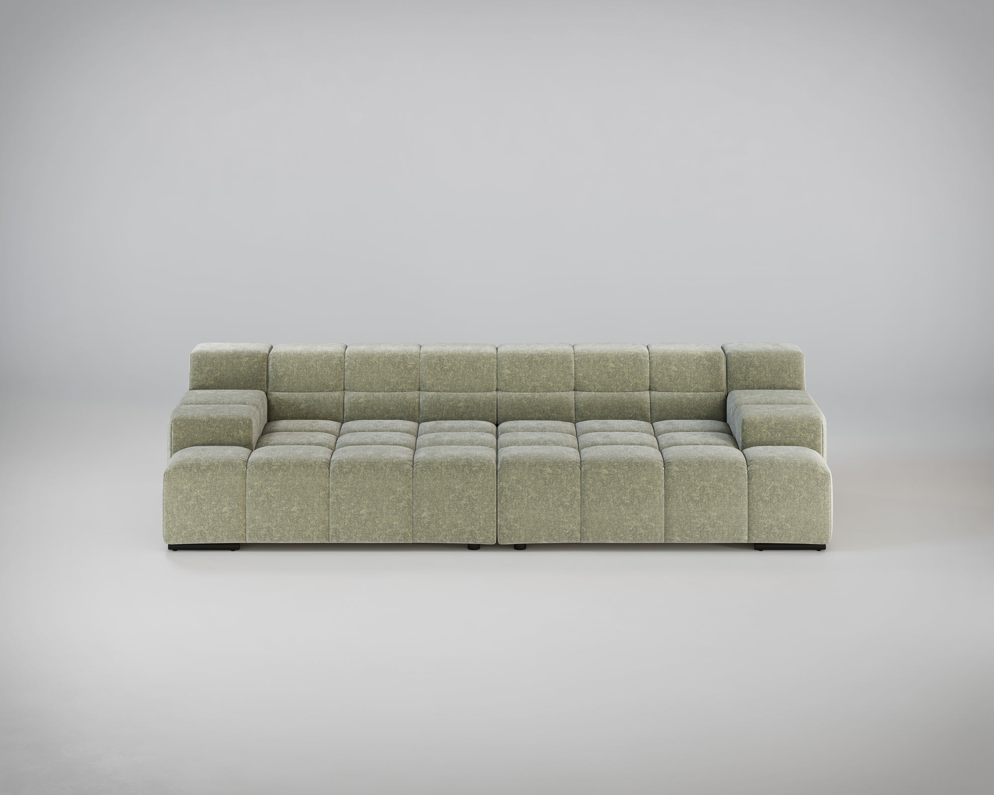 Ein modernes, hellgrünes, modulares Sofa mit einem getufteten Design vor einem schlichten grauen Hintergrund.